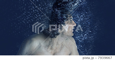 Young man splashing water from his wet hair while bathing 7939667