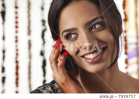 Indian bride talking on a mobile phone 7939757