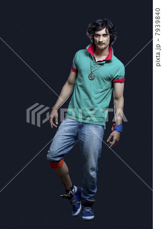 Full length of Indian young man posing against black background 7939840
