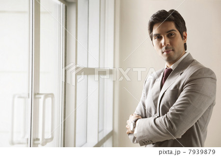 Portrait of business man standing with arms crossed 7939879