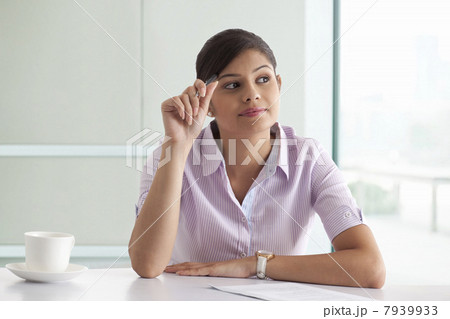 Businesswoman thinking while preparing new project 7939933