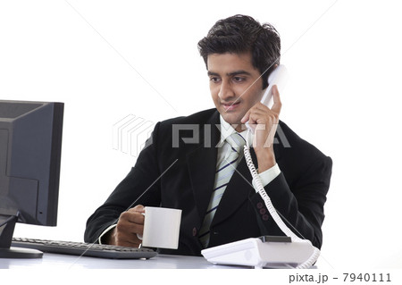 Handsome businessman busy working while having coffee 7940111
