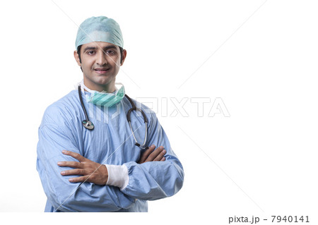 Handsome male surgeon smiling over white background 7940141