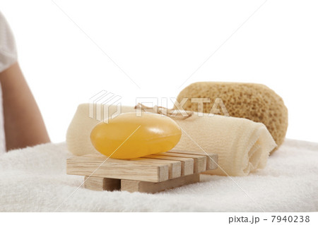 Soap , bath scrub and loofah on a towel 7940238