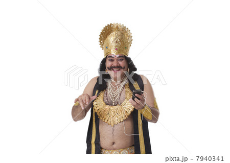Man dressed as Raavan listening to music 7940341