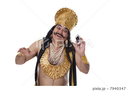 Man dressed as Raavan with a mobile phone 7940347