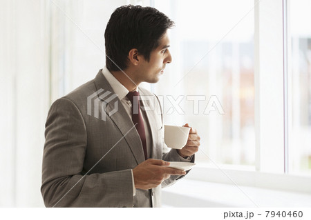 Smart young businessman taking coffee break at office 7940460