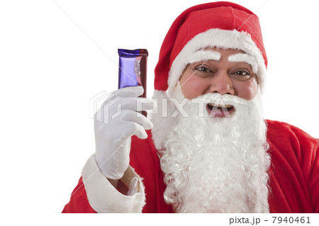 Close-up of cheerful Santa Claus showing chocolate over white background 7940461