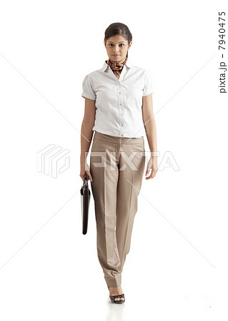 Full length of confident businesswoman carrying briefcase on white background 7940475