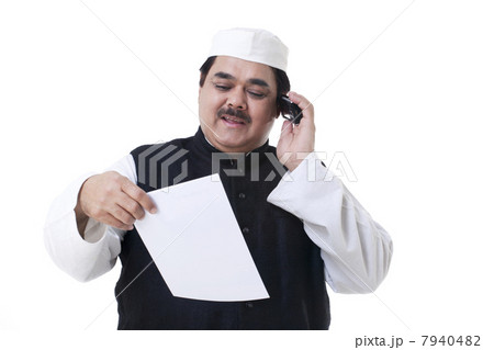 Male politician looking at a document Male politician looking at a document 7940482