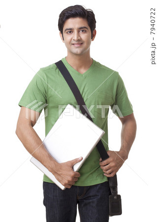 Portrait of happy young male student holding laptop 7940722