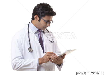 Male doctor writing on clipboard over white background 7940750