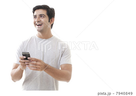 Cheerful young man holding cell phone on white background 7940849