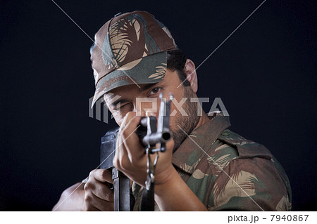 Male soldier aiming gun 7940867