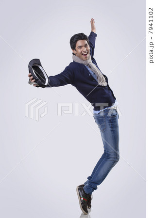 Young man dancing over colored background 7941102