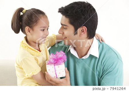 Father giving gift to his daughter Father giving gift to his daughter 7941264