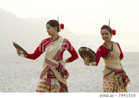 Bihu women dancing with brass plates 7941310