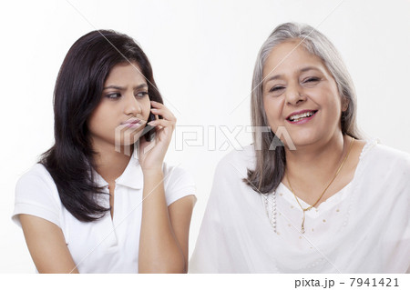 Irritated girl looking at her grandmother 7941421