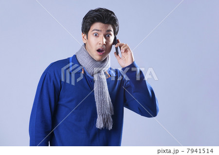 Portrait of surprised man having conversation on mobile phone 7941514
