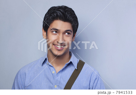 Smiling college student looking up Smiling college student looking up 7941533