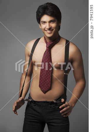 Portrait of shirtless man wearing suspenders and tie Portrait of shirtless man wearing suspenders and tie 7941595