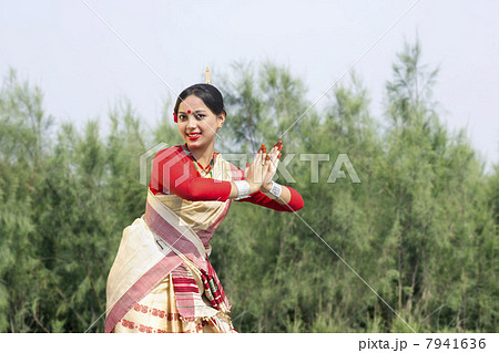 Woman performing Bihu dance 7941636