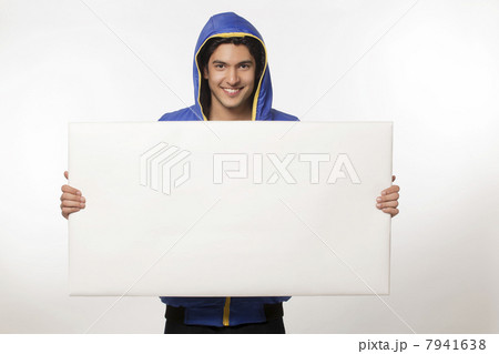 Young man holding bill board 7941638