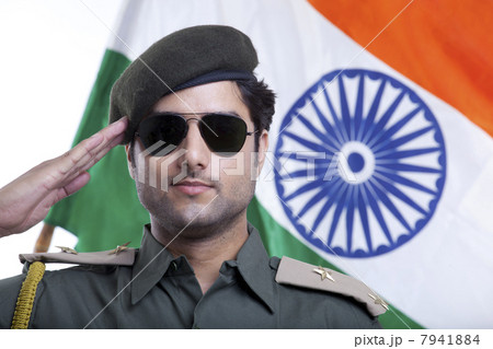 Close-up of a security guard wearing sunglasses while saluting Indian flag 7941884