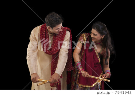 Couple with sticks dancing 7941942