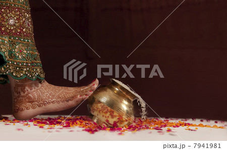 Brides foot kicking over a pot of rice Brides foot kicking over a pot of rice 7941981