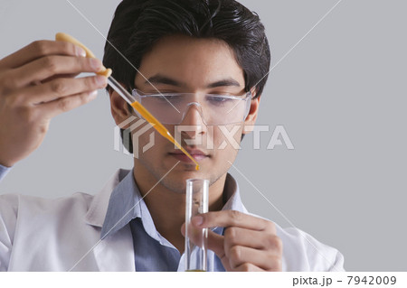 Scientist putting liquid in test tube 7942009