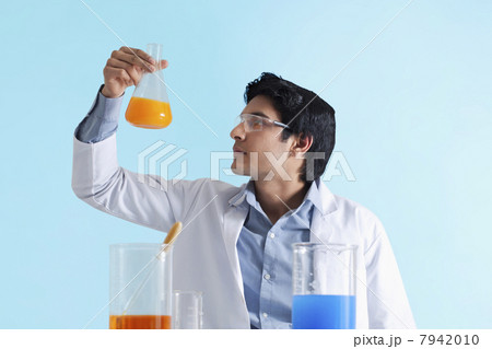 Scientist looking at solution 7942010