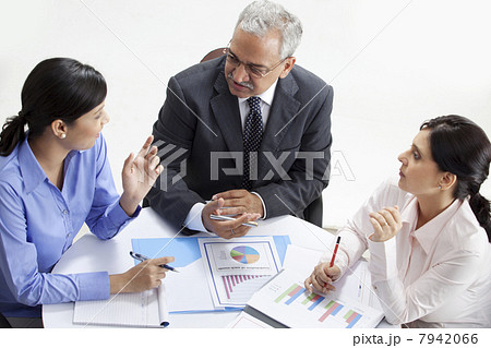 High angle view of professionals discussing together High angle view of professionals discussing together 7942066