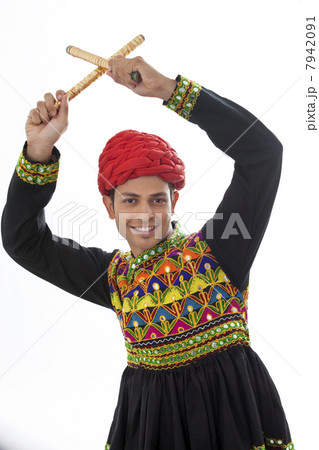 Male dandiya dancer dancing with sticks 7942091