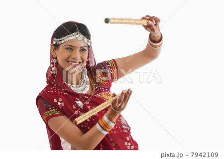 Female dandiya dancer dancing with sticks Female dandiya dancer dancing with sticks 7942109