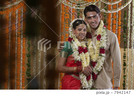Couple wearing garlands during traditional Indian wedding Couple wearing garlands during traditional Indian wedding 7942147
