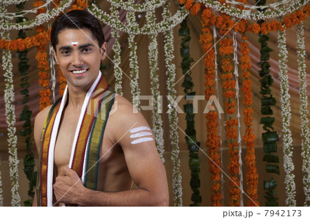 Portrait of young groom wearing traditional Indian clothing 7942173