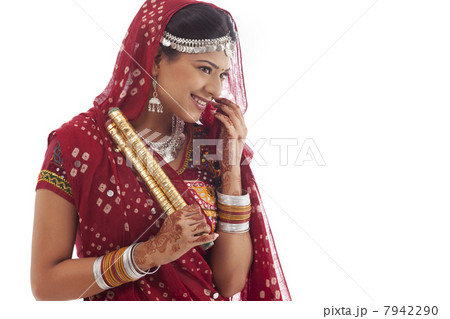Female dandiya dancer with sticks 7942290