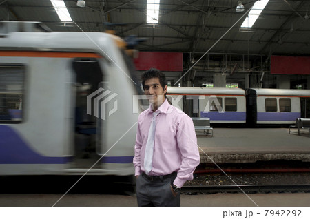Businessman standing at a train station 7942292