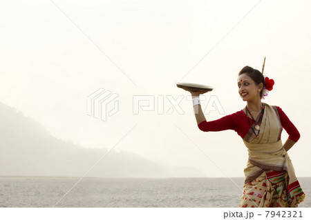 Bihu woman dancing with a brass plate Bihu woman dancing with a brass plate 7942321
