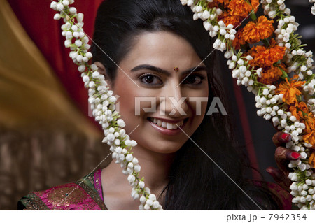 Portrait of smiling young woman with wreath Portrait of smiling young woman with wreath 7942354