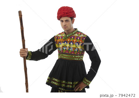 Portrait of a male dandiya dancer with a stick Portrait of a male dandiya dancer with a stick 7942472