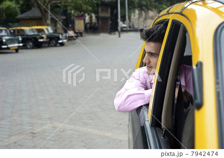 Businessman looking out of a taxi 7942474