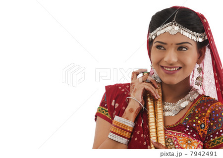 Female dandiya dancer with sticks 7942491