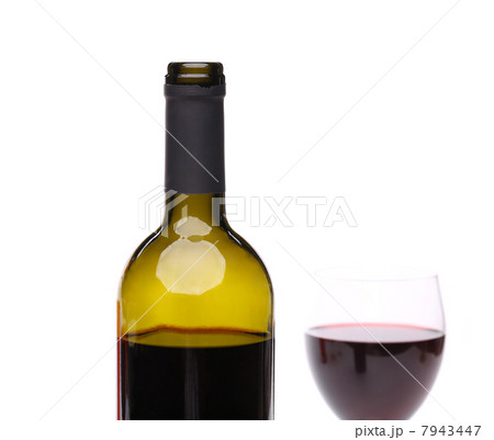 A bottle of red wine with a wine glass. 7943447