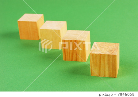 wooden geometric cube on a green background wooden geometric cube on a green background 7946059