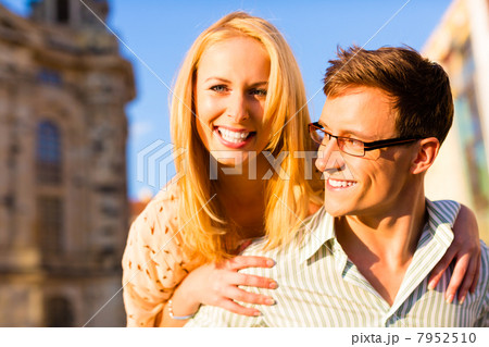 Woman jumping on the back of a man piggyback being happy 7952510