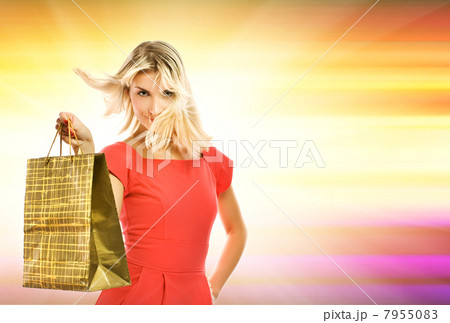 Beautiful young woman with a bag over abstract yellow background 7955083