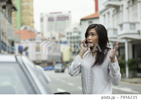 Angry Chinese Business woman talking on phone 7956235