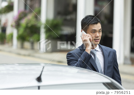Chinese Business man talking on phone Chinese Business man talking on phone 7956251